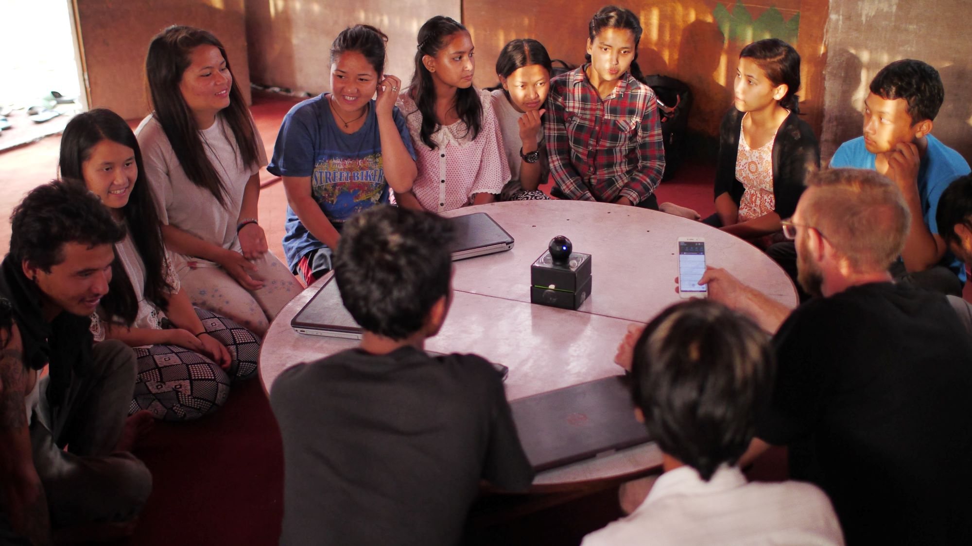 A group of people talking around a table