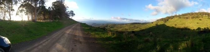 A country road through green hills