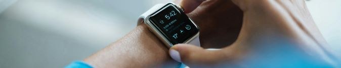 A hand wearing a smart watch