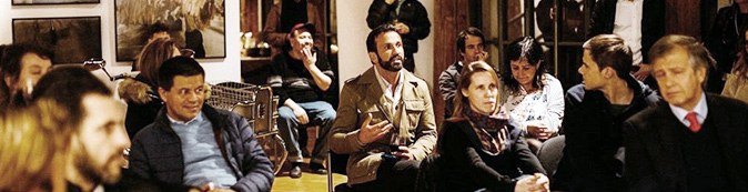 A seated audience listening to a speaker